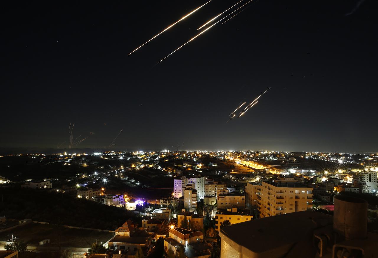 Missiles fired from Iran are seen streaking across the skies over the city of Hebron in the West Bank on June 18, 2025. (AA Photo)