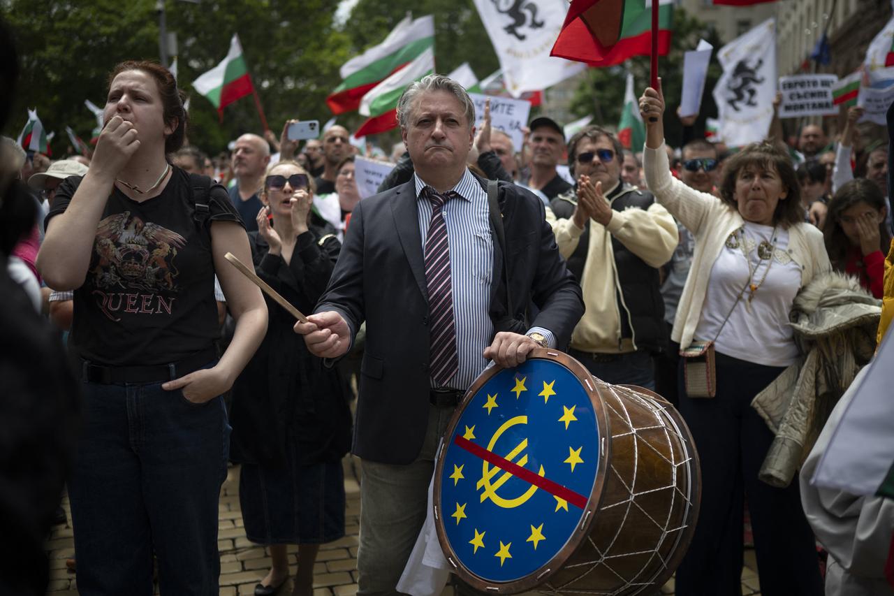 A demonstrator beats a drum marked with a red-crossed euro symbol during an anti-eurozone protest in Sofia on May 31, 2025. (AFP Photo)