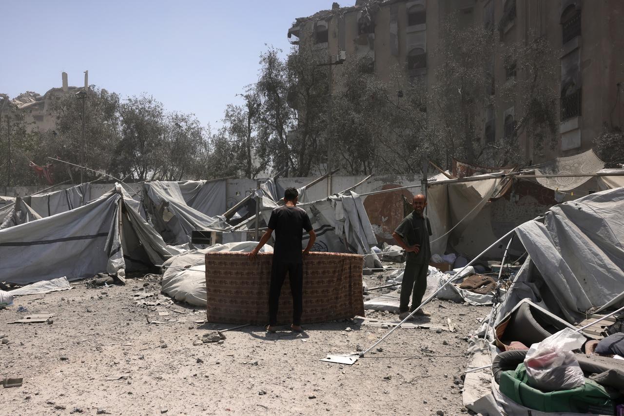 Palestinians check the destruction at a camp for displaced people after an Israeli strike hit a nearby house west of Jabalia, in the northern Gaza Strip, on June 1, 2025, amid the war between Israel and the Palestinian Hamas militant movement. (Photo by BASHAR TALEB / AFP)