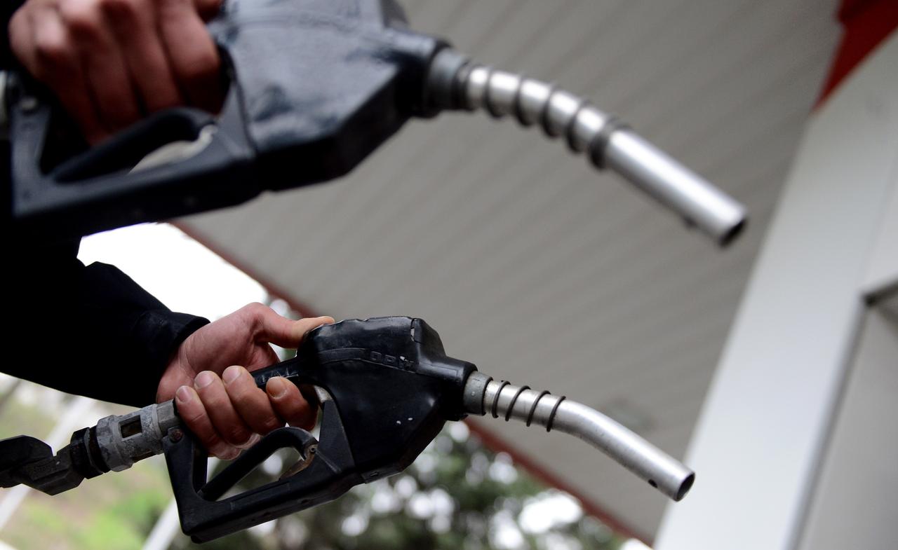 File photo shows a fuel station worker holding petrol and diesel nozzles, accessed on June 20, 2025. (AA Photo)