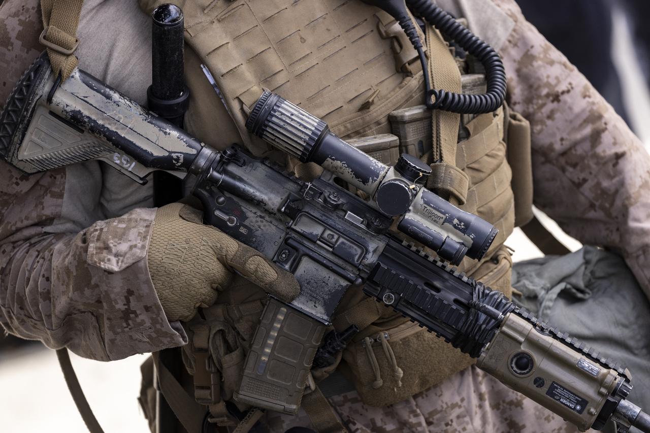 A detail of a HK M27 rifle held by a US marine is seen as he stands guard as demonstrators gather in front of the Metropolitan Detention Center during the "No Kings" national demonstration in Los Angeles on June 14, 2025. (AFP Photo)