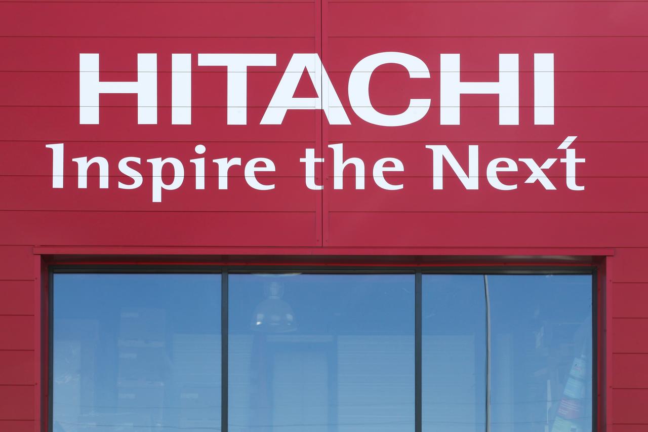 Hitachis logo and slogan displayed on the exterior of a company building in Saint Etienne, France, on June 21, 2020. (Adobe Stock Photo)