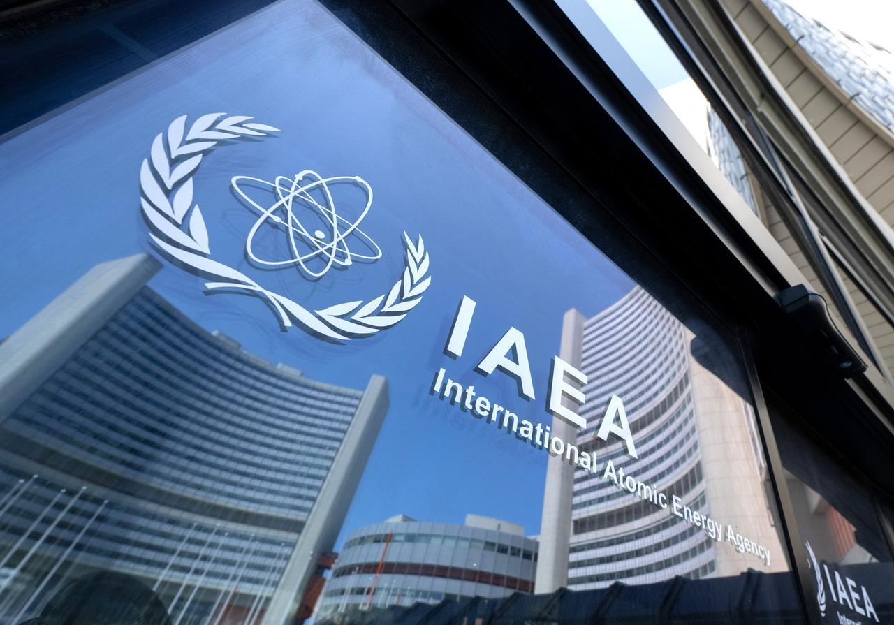 Buildings of the International Atomic Energy Agency (IAEA) headquarters reflect in doors with the agencys logo during the IAEA’s Board of Governors meeting in Vienna, Austria on June 13, 2025. (AFP Photo)