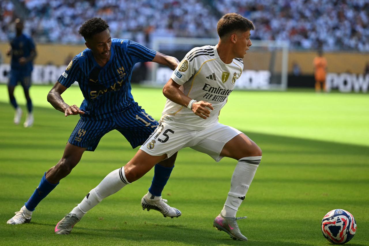 Al Hilals Saudi midfielder #16 Nasser Al-Dawsari (L) fights for the ball with Real Madrids Turkish midfielder #15 Arda Guler (R) during the FIFA Club World Cup 2025 Group H football match between Spains Real Madrid and Saudis Al-Hilal at the Hard Rock stadium in Miami on June 18, 2025. (AFP Photo)