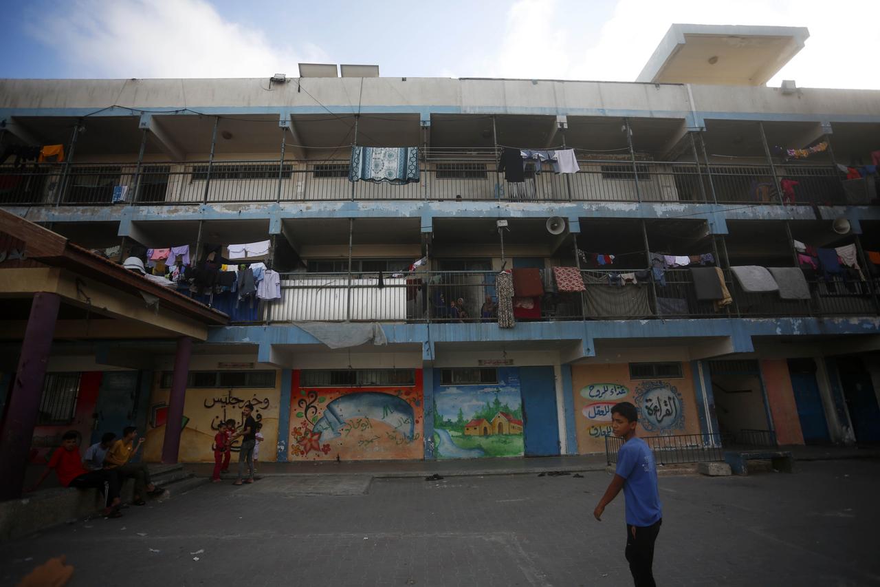 Children staying in the in a school belonging to the United Nations Relief and Works Agency for Palestine Refugees (UNRWA) with their families pass the time as Palestinians sheltering in the school struggle to continue their daily lives without the most basic humanitarian needs in Deir al-Balah, Gaza on June 9, 2025. (AA Photo)