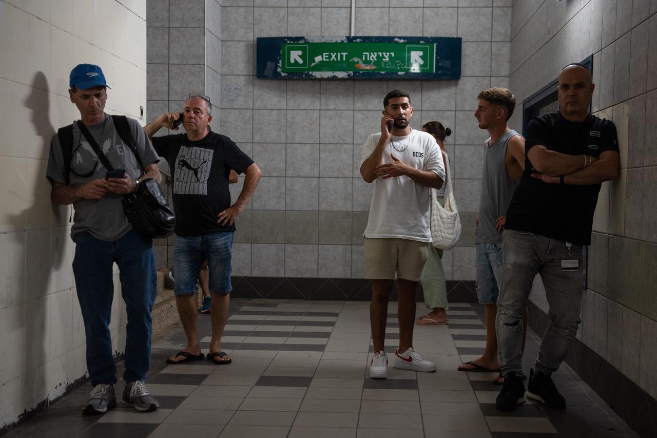 Israelis take shelter during a missile siren alert in Haifa, on June 16, 2025. Israel and Iran traded deadly fire for a fourth day on June 16 in their most intense confrontation in history, fuelling fears of a drawn-out conflict that could engulf the Middle East. (Photo by Maya Levin / AFP)