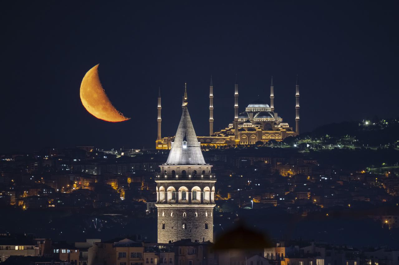 ISTANBUL, TURKIYE - JUNE 20: Half Moon is seen with Grand Camlica Mosque and Galata Tower during night time in Istanbul, Turkiye on June 20, 2025.  ( ?sa Terli - Anadolu Agency )