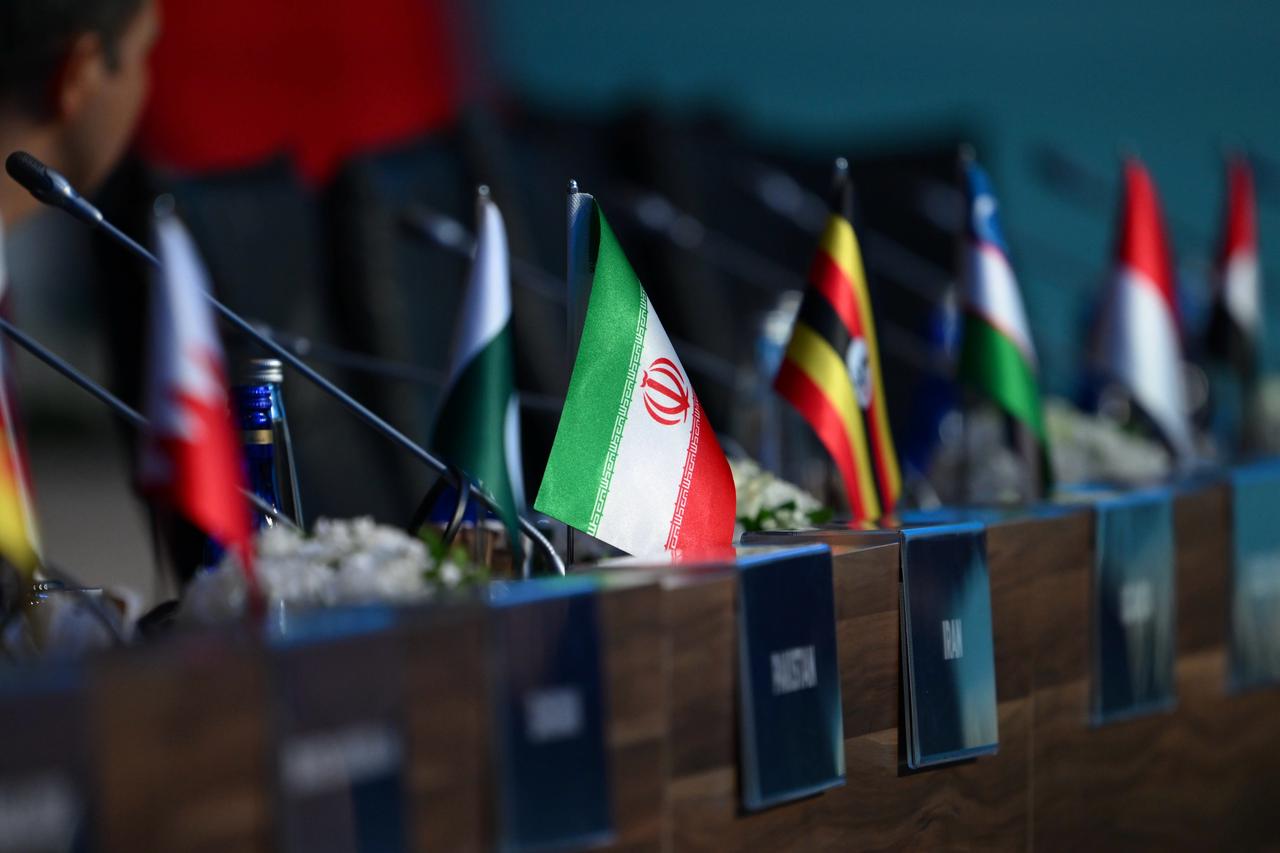 An Iranian flag with a general view of the 51st Meeting of the Council of Foreign Ministers of the Organization of Islamic Cooperation (OIC) in Istanbul, Türkiye, on June 21, 2025. (AA Photo)
