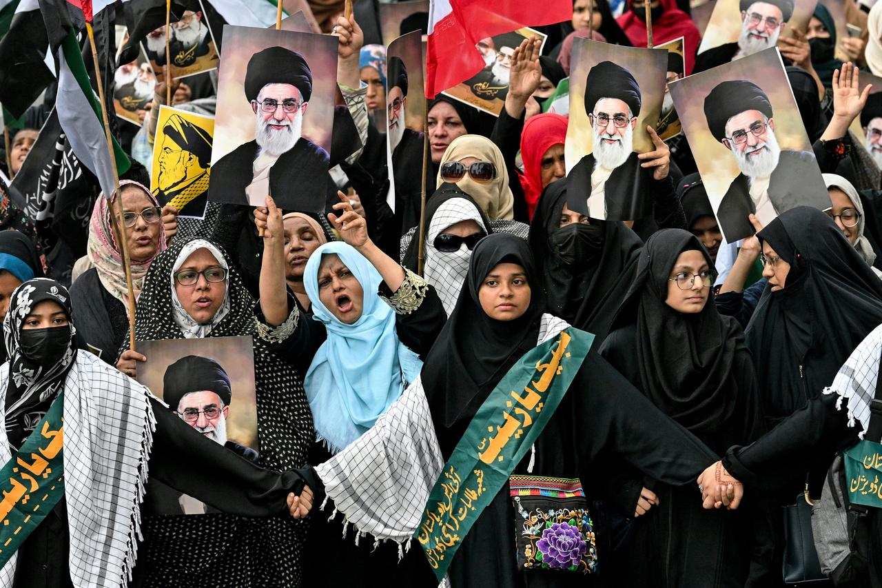 Shiite Muslims hold portraits of Irans Supreme leader Ayatollah Ali Khamenei to condemn US and Israels attacks on Iran, during a protest in Karachi on June 22, 2025. (AFP Photo)