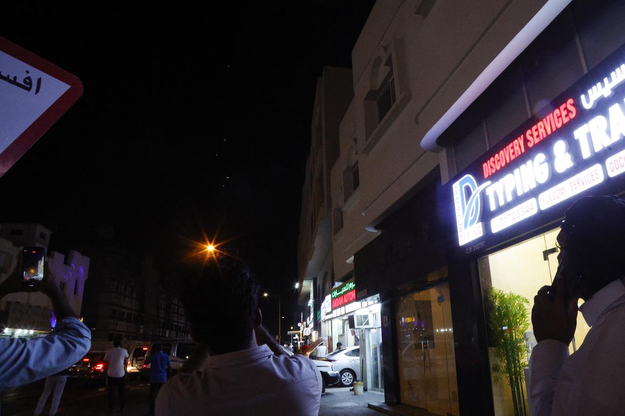 People film projectiles over Doha in Qatar on June 23, 2025. (AFP Photo)