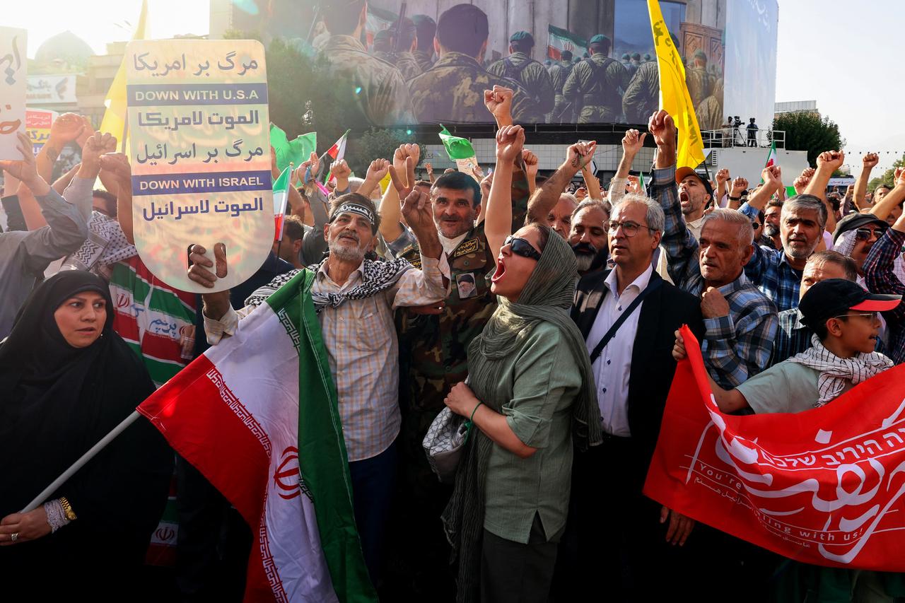 Iranians lift flags and placards during a rally protesting the US attack on Iran in Enghelab Square in Tehran, Iran on June 22, 2025. (AFP Photo)