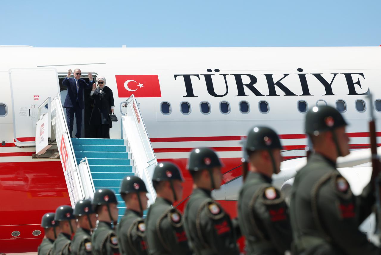 President Recep Tayyip Erdogan and First Lady Emine Erdogan greet officials at Esenboga Airport in Ankara, Türkiye, on June 24, 2025, ( Turkish Presidency / AA Photo))