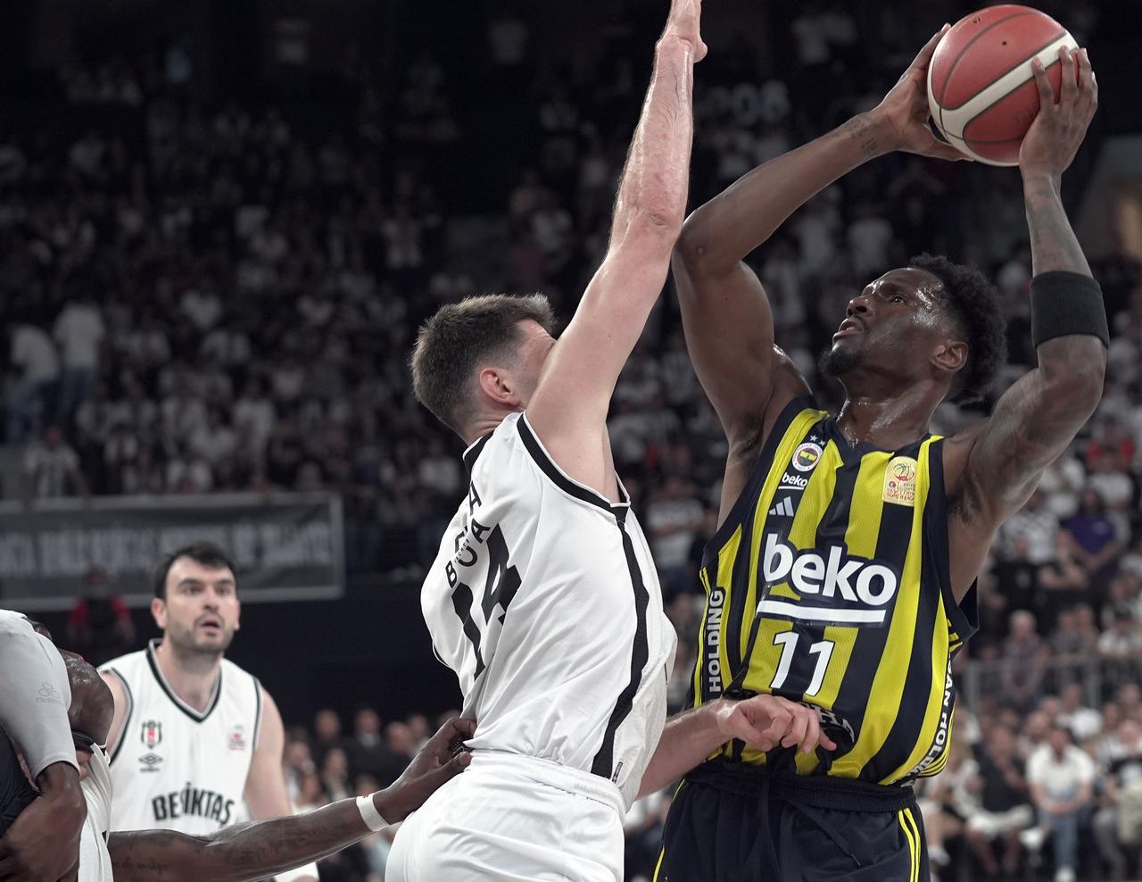Dustin Sleva (14) of Besiktas Fibabanka and Nigel Hayes Davis (11) of Fenerbahce Beko in action during Game 4 of the Türkiye Sigorta Basketball Super League playoff finals at Basketball Development Center in Istanbul, Türkiye on June 23, 2025. (AA Photo)
