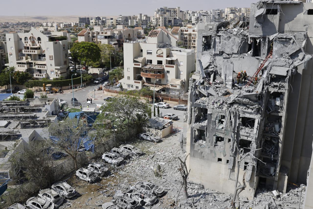 Emergency workers check the damage caused to a building from an Iranian missile strike in Beersheba in southern Israel on June 24, 2025. (AFP Photo)