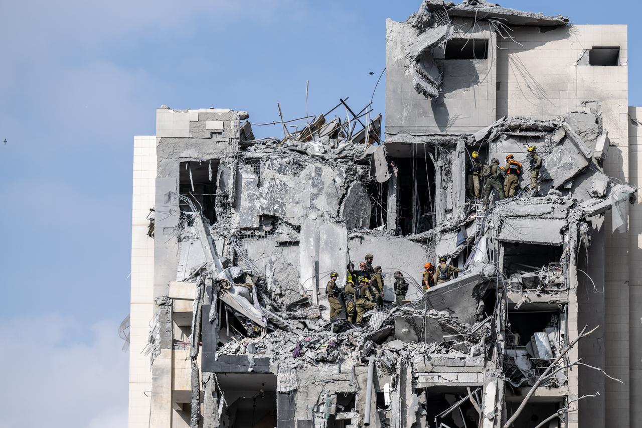 Search and rescue teams conduct search and rescue operations at a building that was heavily damaged and partially collapsed by a missile fired from Iran in Beersheba, Israel on June 24, 2025. (AA Photo)