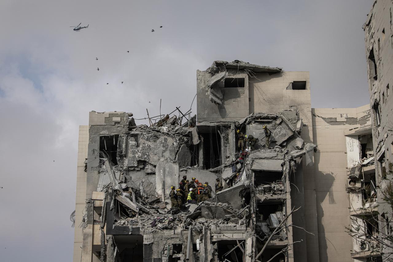 Israeli emergency services and security officers search for casualties in the rubble of a building hit by an Iranian missile in Beersheba in southern Israel on June 24, 2025. (AFP Photo)