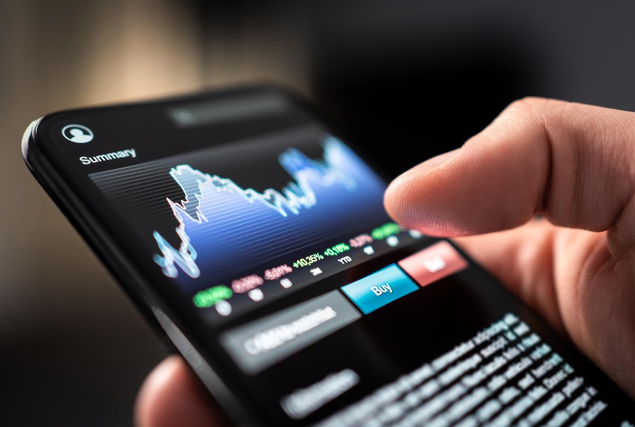 A person monitors cryptocurrency market movements and trading data on a smartphone, accessed on June 24, 2025. (Adobe Stock Photo)