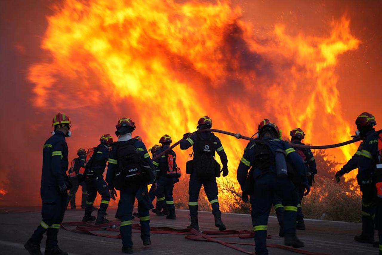Firefighters battle with a large wildfire burning in Kofinas, on the eastern Aegean Chios island, Greece, late Sunday, June 22, 2025. (Photo via Politischios.gr)