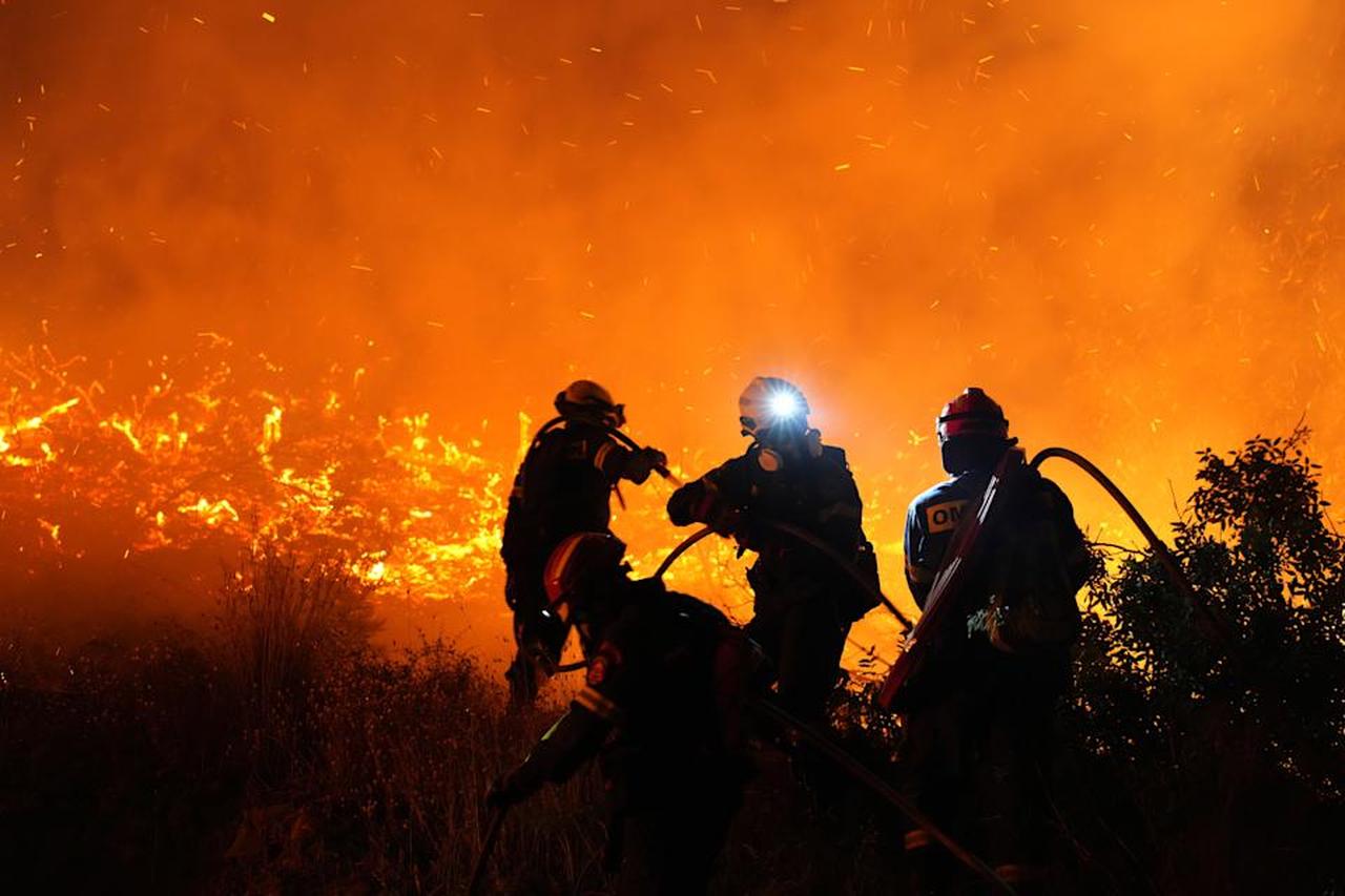Firefighters battle with a large wildfire burning in Kofinas, on the eastern Aegean Chios island, Greece, late Sunday, June 22, 2025. (Photo via Politischios.gr)