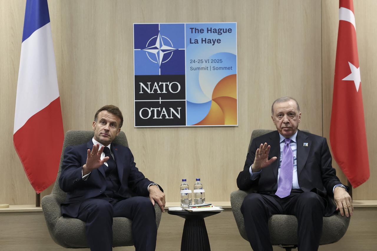 France's President Emmanuel Macron (L) and Turkeys President Recep Tayyip Erdogan gesture during their meeting on the sideline of the North Atlantic Treaty Organization (NATO) summit in The Hague on June 25, 2025. (AFP Photo)