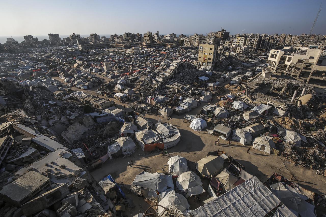 A general view of the makeshift tents housing Palestinians and buildings destroyed in Israeli attacks as deprived of basic needs such as shelter, food and clean water, Palestinians struggle to survive in difficult living conditions in the Sheikh Ridvan neighborhood of Gaza City, Gaza on June 24, 2025.  (AA Photo)