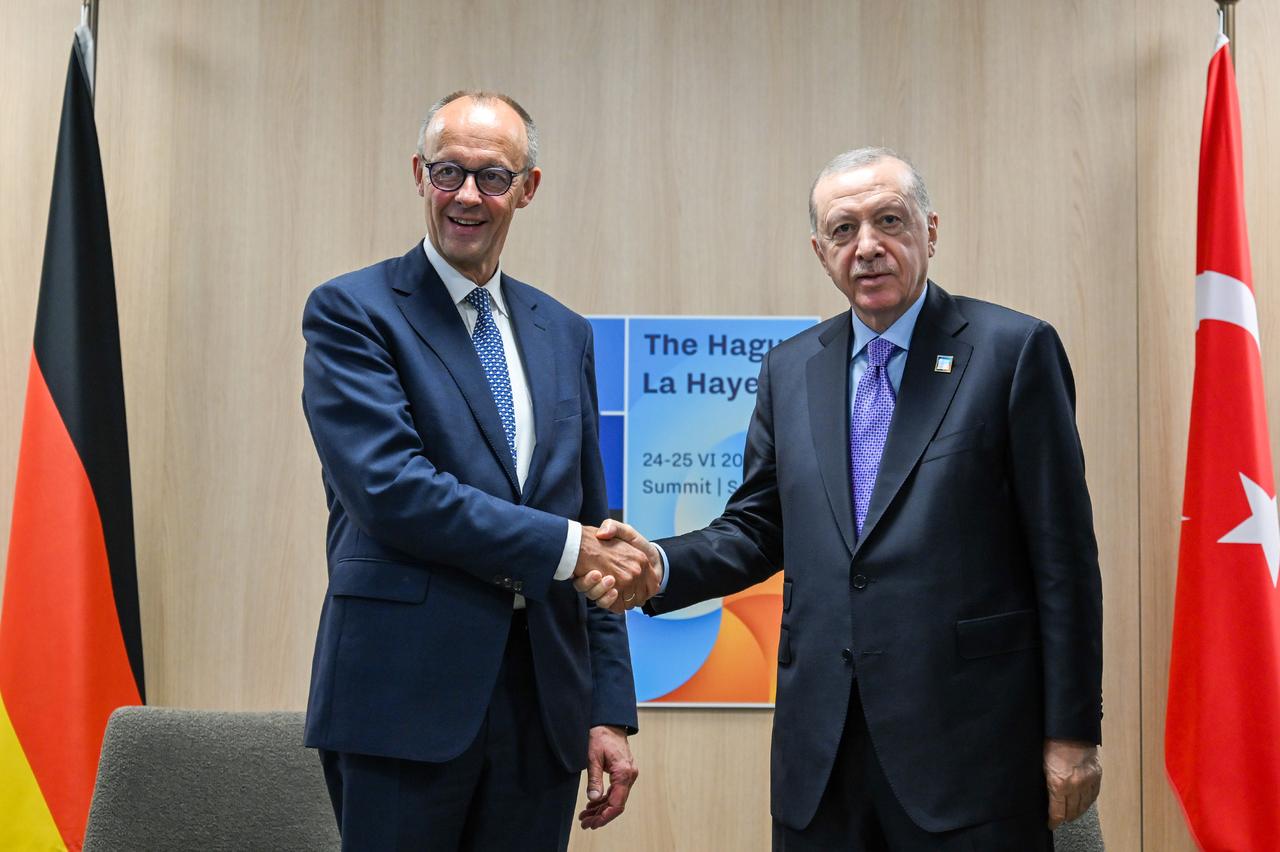President Recep Tayyip Erdogan (R) shakes hand with German Chancellor Friedrich Merz (L) as they pose for prior to their meeting within the NATO Heads of State and Government Summit in The Hague, Netherlands on June 25, 2025. (AA Photo)