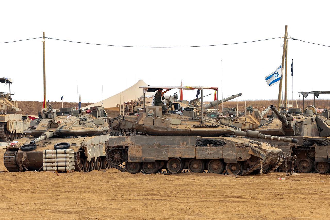 An Israeli soldier sits atop a tank at a position along the Israeli border with the Gaza Strip on June 5, 2025. (AFP Photo)