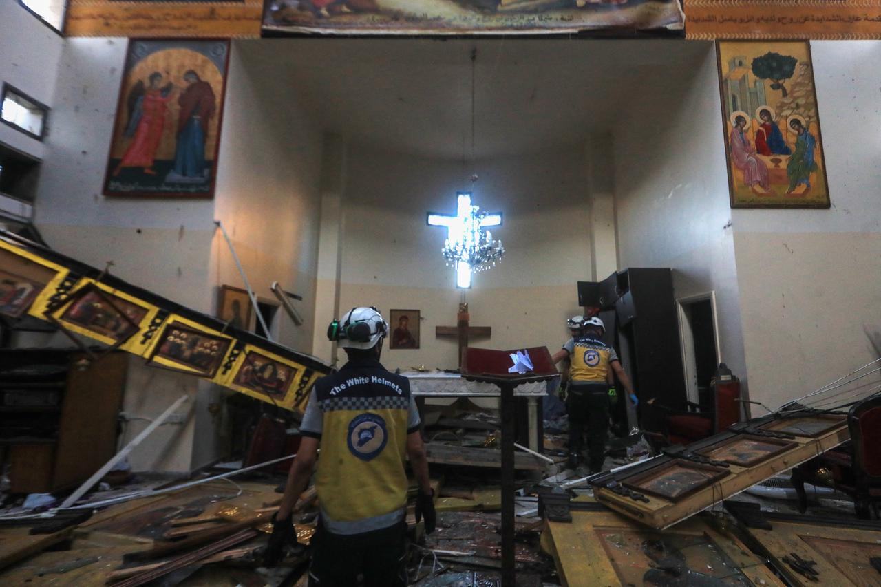 Rescuers inspect the damage at the site of a reported suicide attack at the Saint Elias church in Damascus Dwelaa area on June 22, 2025. (AFP Photo)