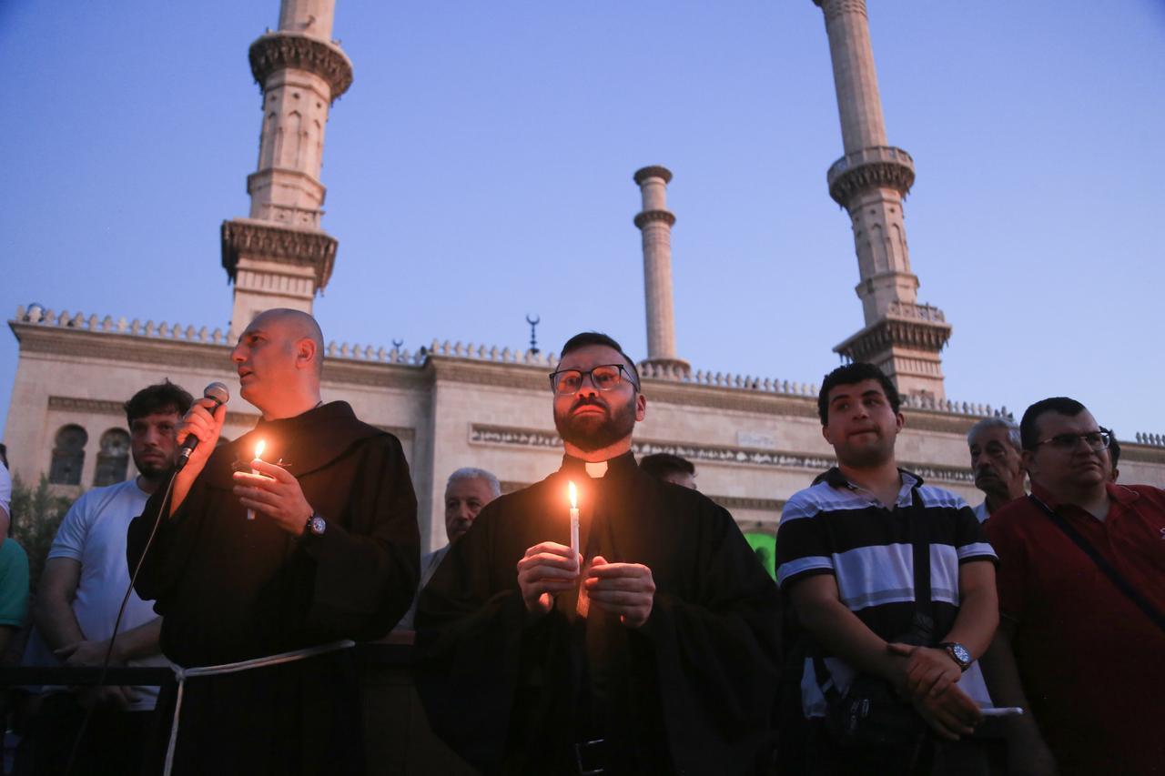 People from different religions gather for candlelight vigil to pay tribute to the victims of Mar Elias Church terror attack, in Aleppo, Syria June 23, 2025. ( Kasim Yusuf - Anadolu Agency )