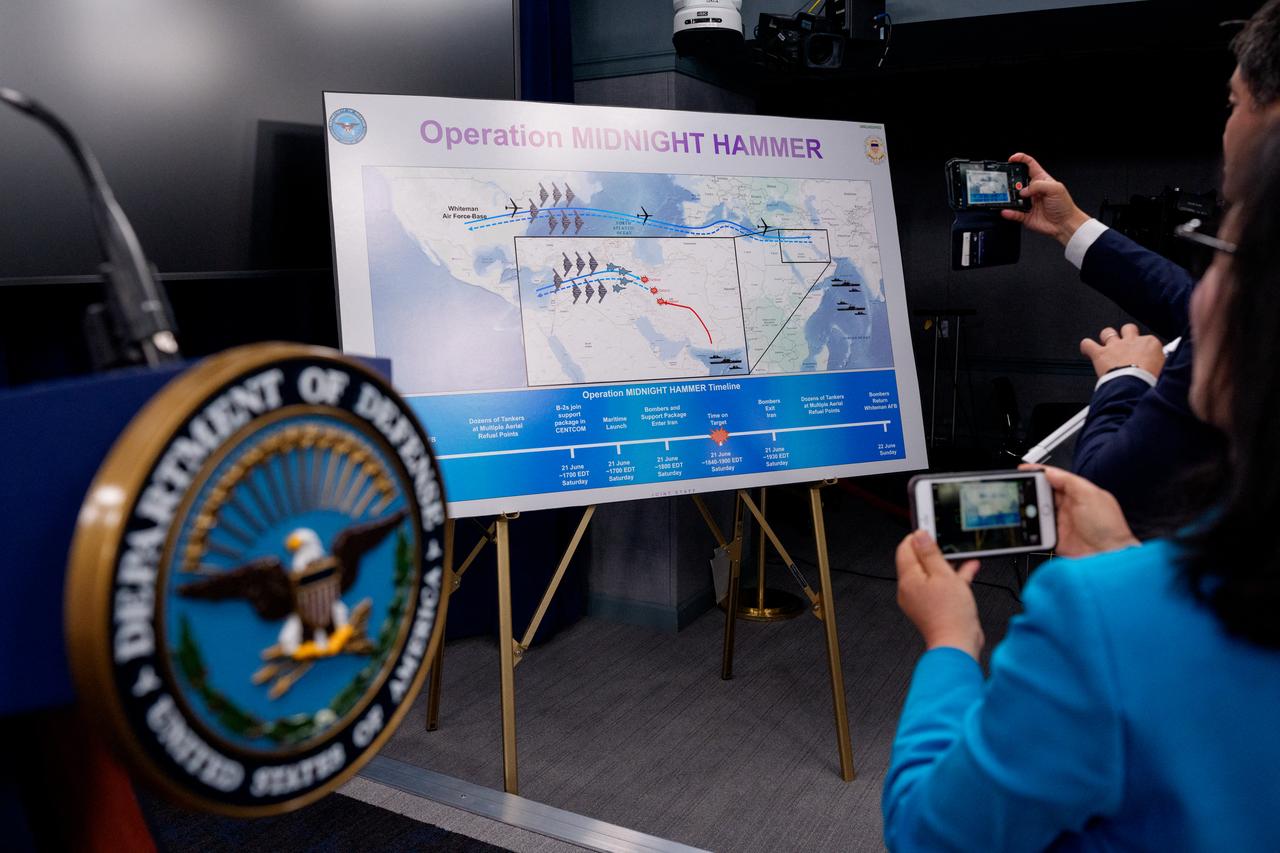 Reporters photograph an operational timeline of a strike on Iran following a news conference with Chairman of the Joint Chiefs of Staff Air Force Gen. Dan Caine and U.S. Defense Secretary Pete Hegseth, speaks during a news conference at the Pentagon on June 22, 2025 in Arlington, Virginia. (AFP Photo)
