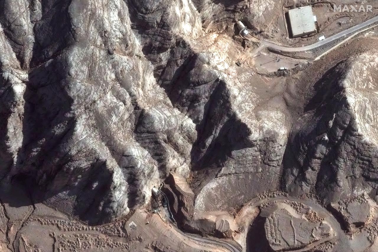 This handout satellite picture provided by Maxar Technologies and taken on June 24, 2025, shows damage caused by recent airstrikes on nearby tunnel entrances near Isfahan nuclear enrichment facility in central Iran. (Photo by Satellite image ©2025 Maxar Technologies / AFP)