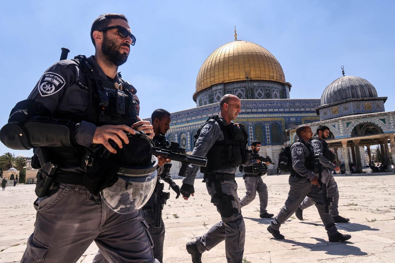 Members of the Israeli security forces walk past the Dome of the Rock mosque as they enter the Al-Aqsa mosque compound in Jerusalem, following the Friday prayers, June 18, 2021. (AFP Photo)