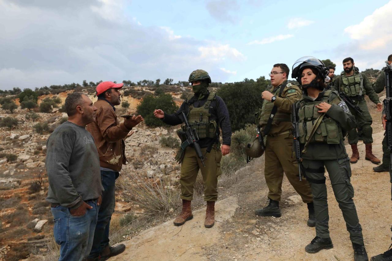 Israeli soldiers confronting Palestinian farmers during the olive harvest as Israeli soldiers intervene against Palestinian farmers harvesting olives in Salem village, east of Nablus in the West Bank in November 2024. (AA Photo)