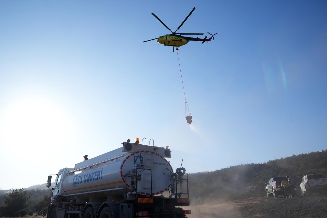 Aerial and ground crews battle a forest fire that spread from Izmir’s Aliaga to Foca, with helicopters, fire trucks, and bulldozers deployed by the Regional Forestry Directorate, June 26, 2025. (AA Photo)