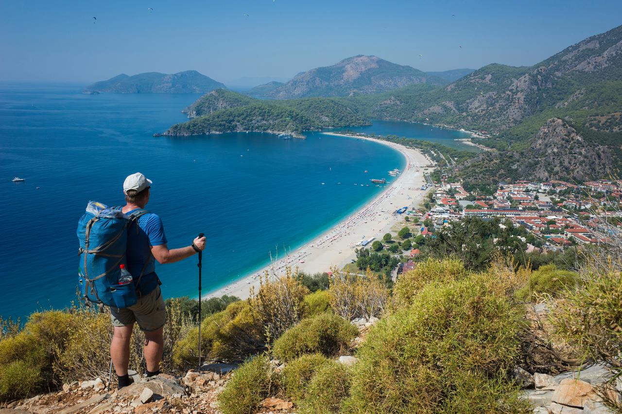 A man hikes along the Lycian Way near Oludeniz beach in Mugla, Türkiye. (Adobe Stock Photo)
