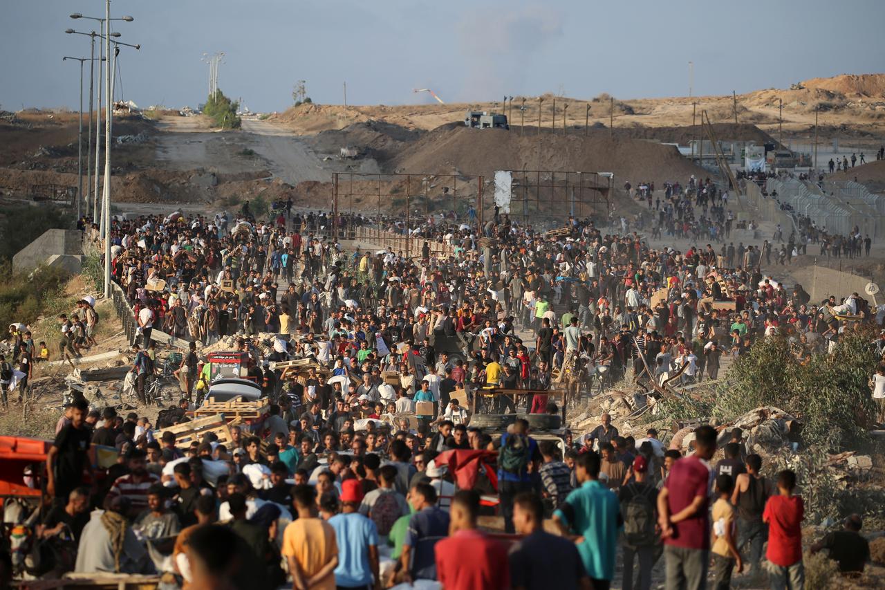 Palestinians gather at an aid distribution point set up by the privately-run Gaza Humanitarian Foundation (GHF), near the Nuseirat refugee camp in the central Gaza Strip on June 25, 2025. (AFP Photo)