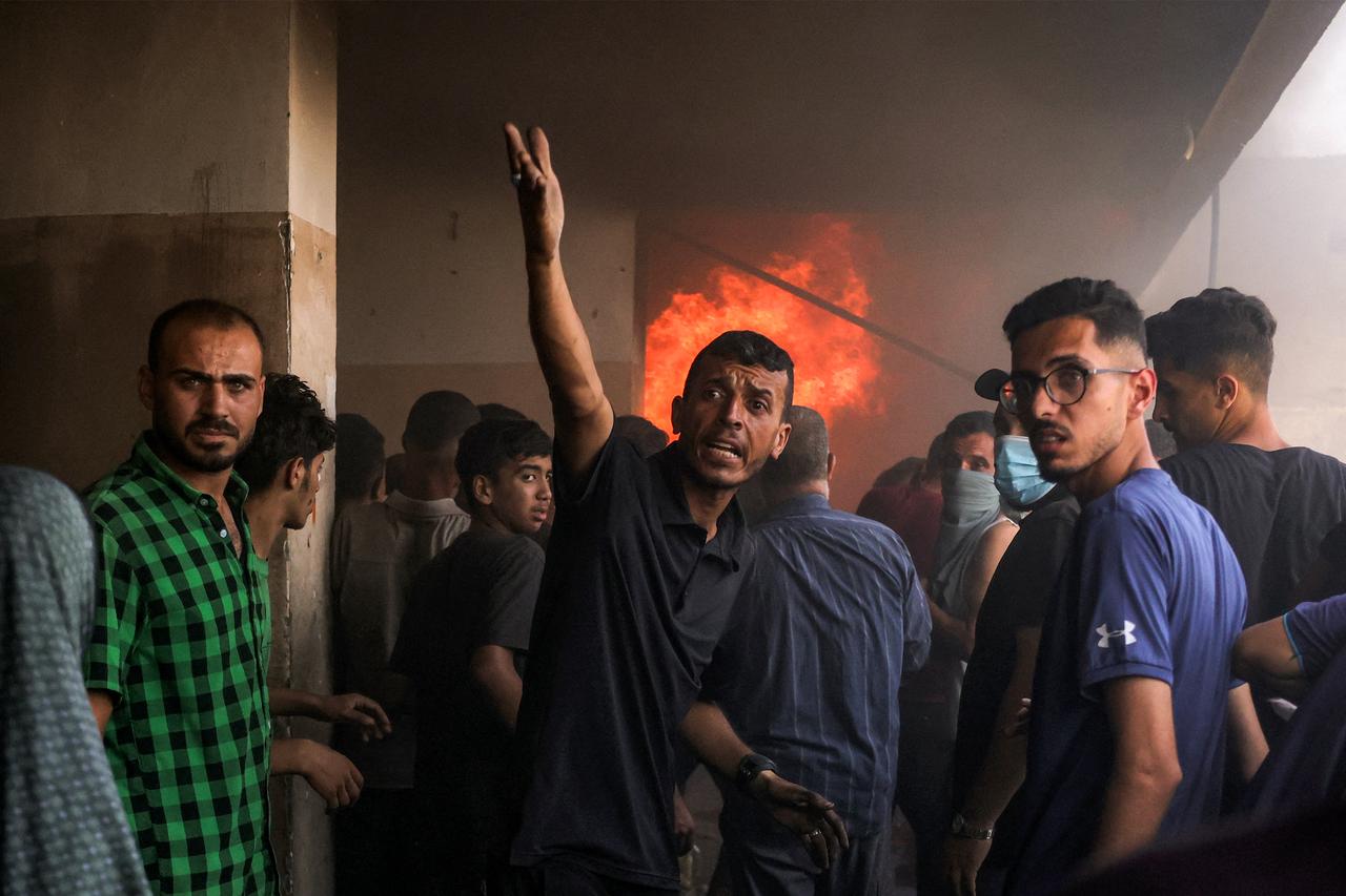 People gather outside a burning classroom during a blaze following an Israeli strike at the UNRWA's Osama bin Zaid school in the Saftawi district in western Jabalia in the northern Gaza Strip on June 27, 2025. (AFP Photo)