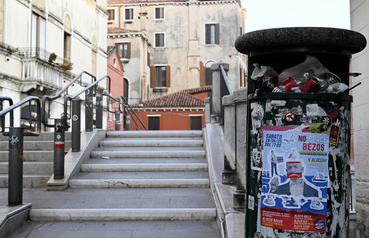 A poster reads "No Space for Bezos" and calls for a protest pasted on a trash bin in Venice, Italy, June 24, 2025. (AFP Photo)