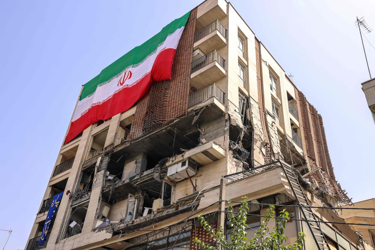 This picture shows a residential building that was hit in an Israeli strike covered with a big Iranian flag, Tehran, Iran, June 25, 2025. (AFP Photo)