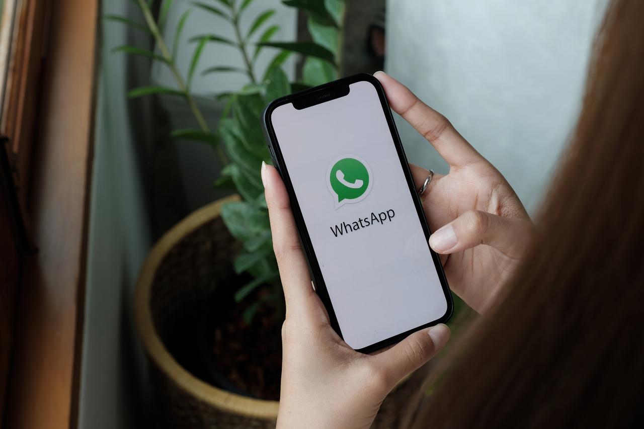 Woman holding an iPhone 12 with WhatsApp on the screen in Chiang Mai, Thailand, on January 15, 2022. (Adobe Stock Photo)