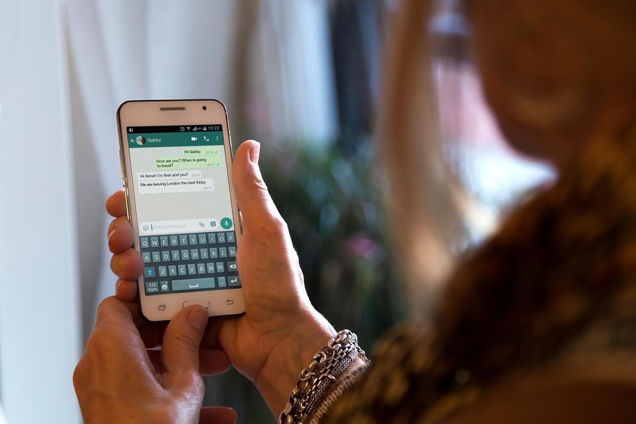 Woman holding a smartphone with a WhatsApp conversation open in Rosario, Argentina, on August 2, 2020. (Adobe Stock Photo)