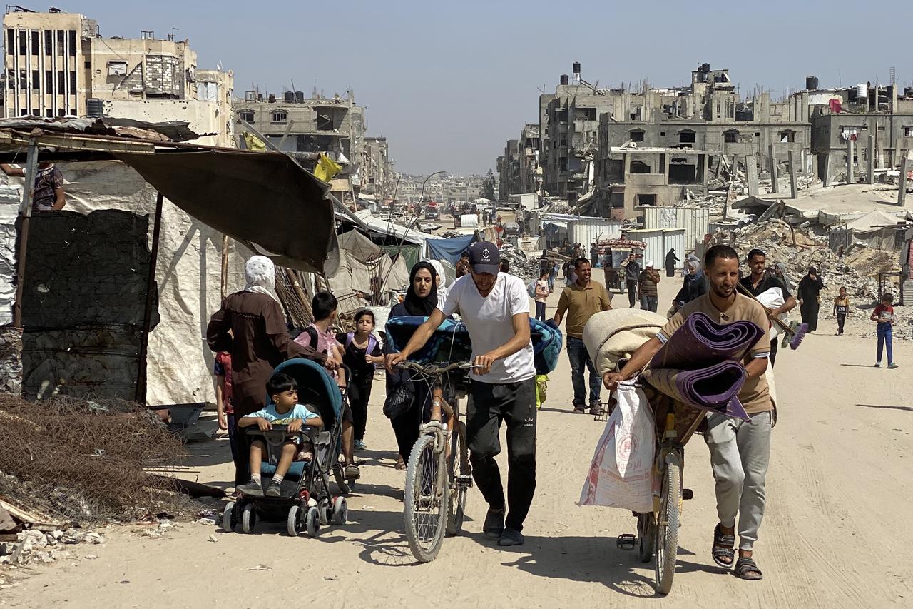 Displaced people walk with their belongings along a road as they flee from Khan Yunis westwards to al-Mawasi in the southern Gaza Strip on June 3, 2025. (AFP Photo)