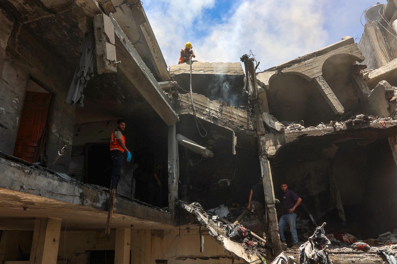 People look for survivors following an Israeli strike that targeted the home of the al-Bursh family in Jabalia in the northern Gaza Strip on June 2, 2025. (Photo by Omar AL-QATTAA / AFP)
