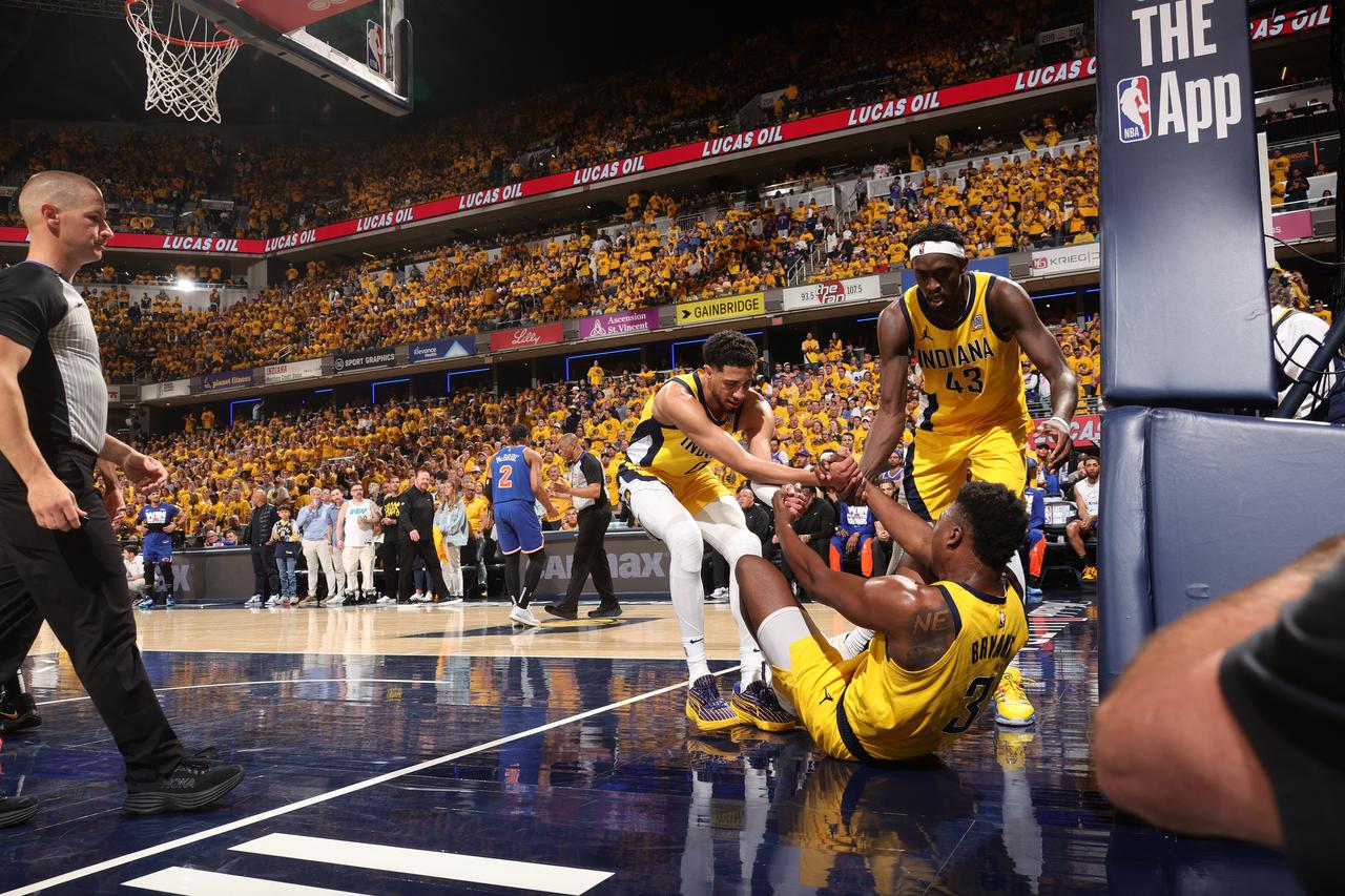 Tyrese Haliburton #0 and Pascal Siakam #43 of the Indiana Pacers help up Thomas Bryant #3 during Game 6 of the 2025 Eastern Conference Finals against the New York Knicks at Gainbridge Fieldhouse in Indianapolis, Indiana, US on May 31, 2025. (Getty Images via AFP)