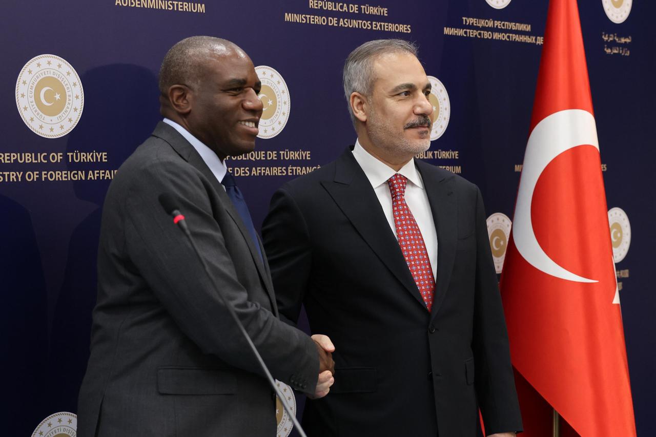 Foreign Minister Hakan Fidan (R) and UK Foreign Secretary David Lammy (L) shake hands as they hold a joint press conference after their meeting in Ankara, Türkiye on June 30, 2025. (AA Photo)
