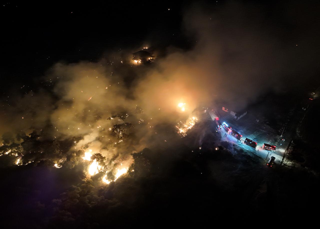 Smoke and flame rise as firefighters continue to extinguish the wildfire that broke out in Aliaga district of Izmir, Türkiye, June 26, 2025. (AA Photo)