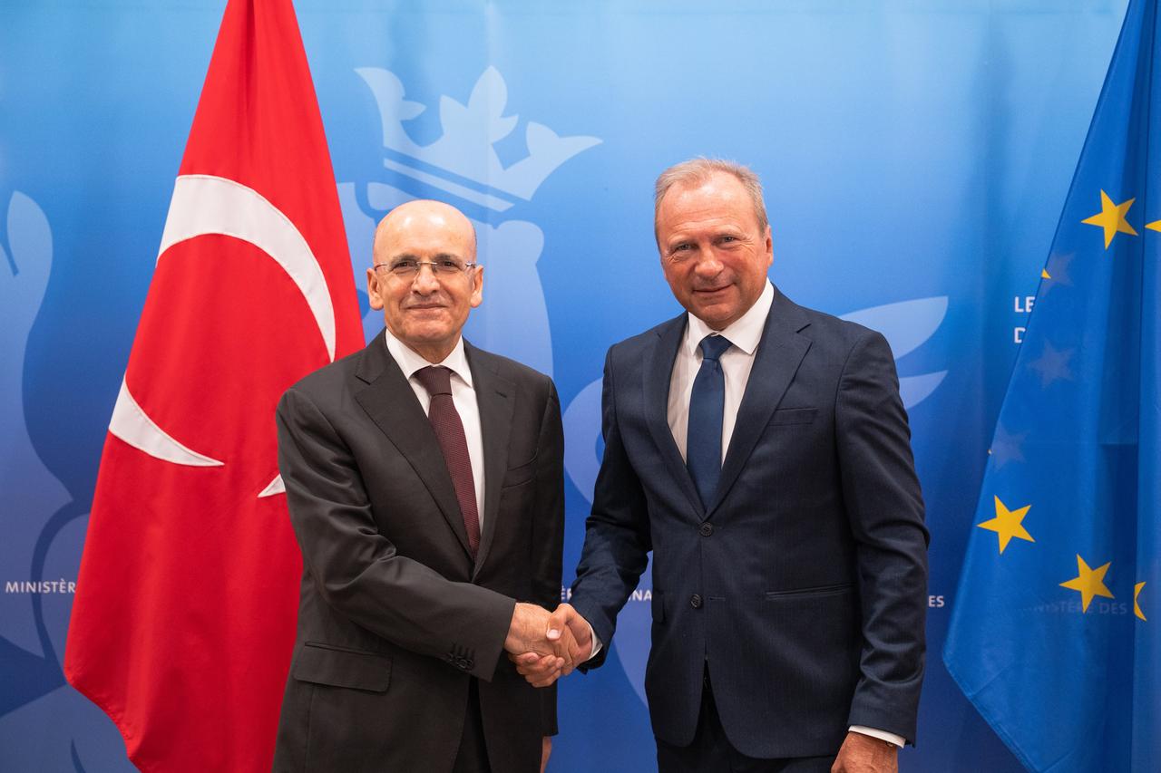 Turkish Finance Minister Mehmet Simsek shakes hands with Luxembourg Finance Minister Gilles Roth during an official visit to Luxembourg, June 4, 2025. (Photo via X/@RothGilles)