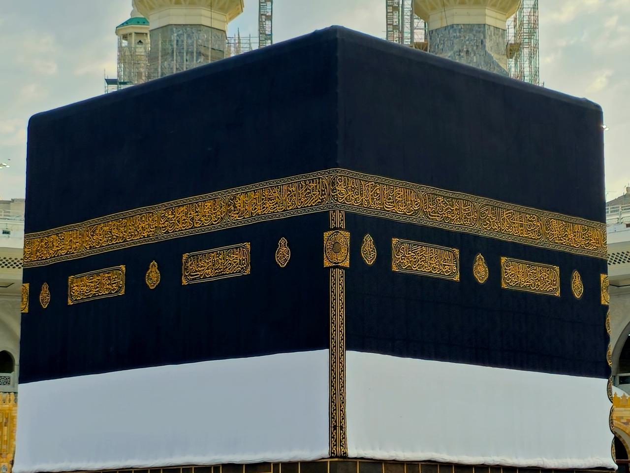 The golden door of the holy Kaaba in Ihram kiswa or clothing, a white cloth symbolizing the Ihram is put on the Kabah building in pilgrimage in Hajj Umrah season, Mecca, Saudi Arabia, June 12, 2024. (Adobe Stock Photo