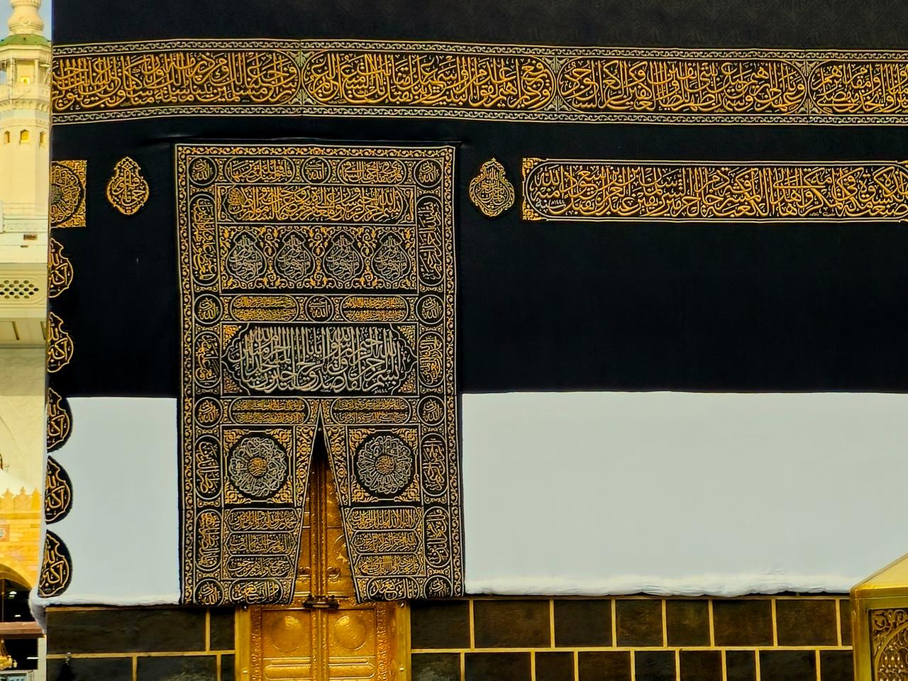 The golden door of the holy Kaaba in Ihram kiswa or clothing, a white cloth symbolizing the Ihram is put on the Kabah building in pilgrimage in Hajj Umrah season, Mecca, Saudi Arabia, June 12, 2024. (Adobe Stock Photo