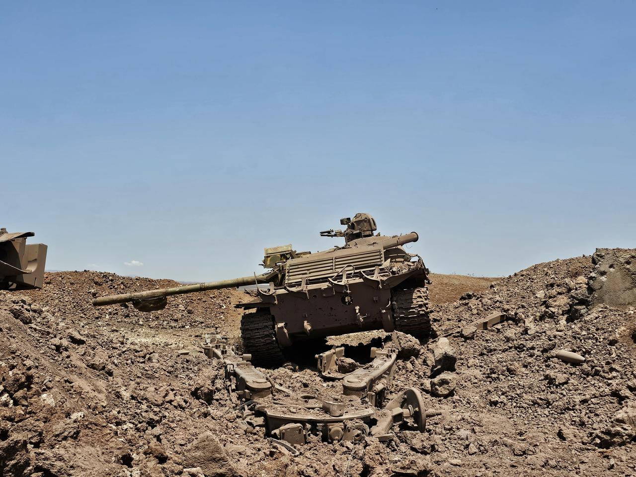 DARAA, SYRIA - JUNE 04: A view of damaged Syrian army tanks and other heavy weapons is seen in the Yarmouk area, after Israeli artillery fire hit the area in response to rockets allegedly launched into Daraa, Syria, on June 04, 2025. Israeli forces conducted artillery shelling on the Yarmouk Basin area in Daraa province in southern Syria late Tuesday following claims that two rockets were fired from the area toward the Golan Heights, the Syrian state news agency SANA reported. The Israeli Broadcasting Authority (KAN) said earlier that two rockets were launched from Daraa which landed in an open area in the Golan Heights. The projectiles’ origin remains unclear.  ( Muhammed Malik Hattab - Anadolu Agency )